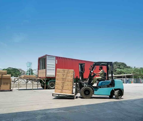 A truck being loaded with a forklift